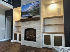 a living room with a fireplace and built in shelves