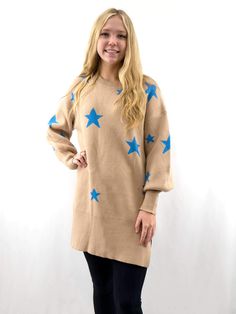 beige long sweater with blue stars on model from front Trendy Crew Neck Sweater Dress For Winter, Long Sleeve Sweater With Star Print For Fall, Long Sleeve Star Print Sweater For Fall, Casual Crew Neck Sweater With Star Print, White Winter Sweater With Star Print, Oversized Star Print Sweater, Winter Long Sleeve Star Print Sweater, Long Sleeve Star Print Winter Sweater, Winter Star Print Long Sleeve Sweater