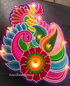 an intricately decorated diya with lit candles