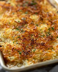 a casserole dish is topped with cheese and parsley