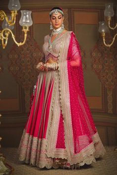 Rani pink toned attached cancan kalidar lehenga with cypress vine striped gota, badla, dori intricate embroidery and heavy tassel ornamentations. Paired with a half sleeves flattering V neckline padded blouse with floral dori, gota jaal embroidery, dangling glass beads hem detail and heavy border embellished net dupatta. - Aza Fashions Bollywood Pink Saree With Tilla Details, Bollywood Style Pink Saree With Tilla, Pink Bollywood Saree With Tilla, Festive Pink Tilla Dupatta, Semi-stitched Pink Lehenga With Tilla Details, Pink Lehenga With Tilla For Diwali, Pink Semi-stitched Lehenga With Tilla, Pink Tilla Choli For Diwali, Pink Semi-stitched Dupatta With Tilla