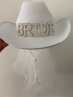 a white hat with the word bride written on it