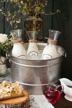 three bottles of milk are in a bucket