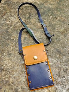 "This original bag from our handmade  tan and navy blue italian genuine leather 100% which offers great protection for your best friend. This elegant leather phone case is specially designed for the Phone models with pocket for card holder for 3-5 cards, ID, some cash. belt loop -5cm or 2\",  cross body strap -115 cm or 45\" Stitched with off white thread . if you like other color thread (brown, black, off white, red,blue, dark blue, yellow, pink, light green) please tell me :) Sleeve closes  with one silver press button and we use silver studs . If you like brass studs , just contact me :) The phone is fully protected by screws. Full guarantee, without scratching To customize your purchase, you can choose from the options MODEL phone. To purchase this item, click on the green 'add to cart Blue Leather Phone Bag For Travel, Blue Leather Phone Bag With Cell Phone Pocket, Blue Leather Phone Bag, Blue Leather Wallets With Cell Phone Pocket, Blue Leather Wallet With Cell Phone Pocket, Leather Phone Bag, Turquoise Leather, Original Bags, Money Clip Wallet