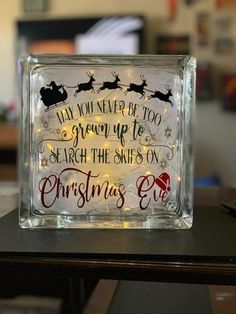 a glass block with christmas lights and santa's sleigh on it