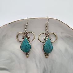 These are beautiful turquoise earrings from Nepal.  Each pair of earrings is handcrafted and created with Tibet silver and turquoise inlay. Each earrings has 925 silver hook. Weight: each earring is 6.9 g They are a nice size for those of you who like your jewellery to make a true statement. The handcraft job is done very nicely.  All of our jewellery are handpicked from the best craftsmen from Kathmandu as we care not only about beauty but about quality as well.   The earrings in real life look Elegant Turquoise Danglers As A Gift, Elegant Turquoise Danglers For Gift, Artisan Turquoise Nickel-free Earrings, Artisan Nickel-free Turquoise Earrings, Handmade Bohemian Turquoise Teardrop Earrings, Bohemian Turquoise Teardrop Earrings For Jewelry Making, Artisan Turquoise Pierced Earrings, Traditional Handmade Sterling Silver Teardrop Earrings, Turquoise Teardrop Earrings For Jewelry Making