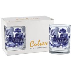 two blue and white glass tumblers sitting in front of a box on a white background