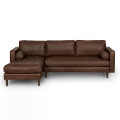 a brown leather sectional sofa with footstool and ottoman in front of a white background