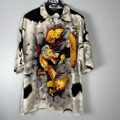 Korean Dragon Shirt Nwt Y2k Deadstock Vintage Korean Sports Shirt. This Incredible Short Sleeved Button Down Shirt Has The Coolest Orange, Yellow And Red Dragon Design On Both The Front And Back. Flowy Comfortable Fabric. This Item Has Not Been Worn Or Washed And Has Its Original Tags. Size Xxl Pit To Pit 26 Inches, Length 32 Inches #Dragon #Vintage #Korean #Alt #Y2 Yellow Graphic Print Button-up Top, Yellow Button-up Top With Graphic Print, Yellow Graphic Print Button-up Shirt, Yellow Button-up Shirt With Graphic Print, Yellow Printed Tops With Camp Collar, Yellow Printed Collared Shirt, Korean Dragon, Dragon Shirt, Sports Shirt