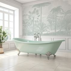 a bathroom with a claw foot bathtub and wallpaper in the background that has palm trees on it