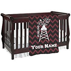 a baby crib with a black and red chevroned blanket that says, your name