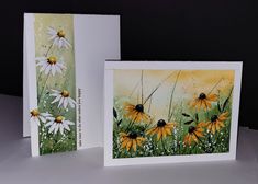 two greeting cards with daisies on them, one is yellow and the other is white