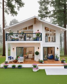 a small white house with lots of windows and balconies on the second floor