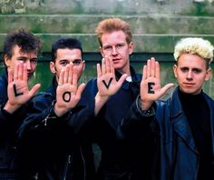 three young men are holding their hands up with the word love spelled on each hand