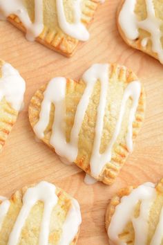 small pastries with white icing on a wooden surface