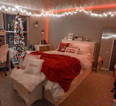 a bed room with a neatly made bed and a christmas tree