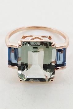 Fine emerald cut green amethyst with London Blue topaz gemstones set in solid 14KT rose gold.   Details of the ring  Gem: Green Amethyst  Center Gem size: 12x10 mm (LxB) Center Gem weight: 4.90ct Side gemstone: London Blue Topaz  Side Gems size: 6x3 mm (LxB) Side Gems weight: 0.81 cts Total Gem weight: 5.71 carats #goldring#weddingring#engagementring#statementring#goldjewellery#designerjewellery#semipreciousstone#semipreciousgems#daintyrings#etsyseller#etsy#etsyshop#handcrafted#costumejewellery Fine Jewelry Rings With Green Amethyst Gemstone Accents, Green Amethyst Jewelry With Gemstone Accents, Fine Jewelry With Green Amethyst And Accent Stones, Fine Jewelry Green Amethyst Ring With Accent Stones, Green Amethyst Ring With Accent Stones Fine Jewelry, Green Amethyst Ring With Accent Stones, December Birthstone Ring, Handmade Jewelry Box, London Blue Topaz Ring