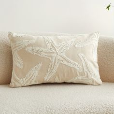 a white pillow sitting on top of a couch