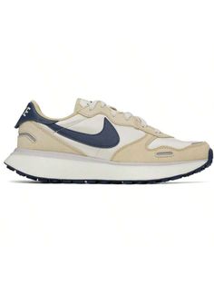 Nike 
Beige & Navy Phoenix Waffle Sneakers 
Low-top canvas and suede sneakers in beige. 
. Grained leather trim in navy throughout 
. Lace-up closure 
. Logo embroidered at tongue 
. Padded collar 
. Swoosh appliqué at sides 
. Logo printed at heel tab 
. Mesh lining 
. Sculptural foam rubber midsole 
. Treaded rubber sole 
Please note that this item may be shipped only within North America. 
Supplier color: Light orewood brown/Midnight navy 
Upper: textile. Sole: rubber. 
Made in Indonesia. 
24 Cream Low-top Sneakers With Studded Outsoles, Beige Low-top Running Shoes With Rubber Waffle Outsoles, Beige Low-top Sneakers With Studded Rubber Outsoles, Cream Sports Sneakers With Rubber Waffle Outsoles, Sporty Cream Sneakers With Rubber Waffle Outsoles, Casual Cream Sneakers With Studded Outsoles, Cream Sneakers With Round Toe For Running, Cream Running Shoes With Round Toe For Jogging, Cream Running Shoes For Jogging