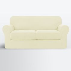 a white couch sitting on top of a gray floor