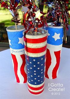 two red, white and blue vases with stars on them sitting on a table