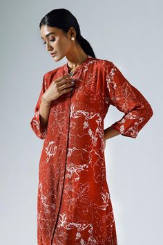 Red long tunic with all-over contrasted abstract floral prints. Comes with co-ordinating midrise pant.
Components: 2
Pattern: Printed
Type Of Work: Abstract Floral
Neckline: Mandarin
Sleeve Type: Three Quarter
Fabric: Crepe
Color: Red
Other Details: 
Pocketed tunic and pant
Length:
Tunic: 44 inches
Sleeves: 17 inches
Pant: 39 inches
Approx. product weight (in gms): 300
Closure:
Kurta: Front concealed buttons
Pant: Zip fly fastening with a single hook fastening on one side
Occasion: Work - Aza Fa Red Long Sleeve Blouse With Printed Motifs, Red Floral Print Kurta For Spring, Red Long Sleeve Kurta With Floral Print, Red Floral Print Spring Kurta, Red Printed Kurta For Spring, Red Silk Kurta For Spring, Spring Red Floral Print Kurta, Red Kurta With Printed Motifs For Spring, Red Straight Kurta For Spring