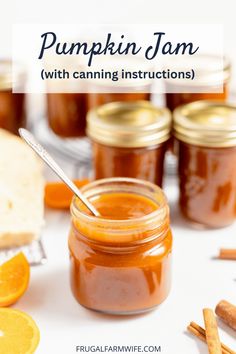 pumpkin jam with canning instructions in glass jars and orange slices on the table next to it