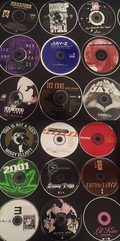 many different cd's are displayed on a black surface with white writing and numbers