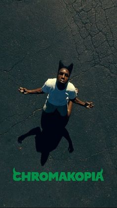 an overhead view of a man standing in the street with his arms spread out and hands outstretched