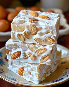 three pieces of cake sitting on top of a blue and white plate next to oranges