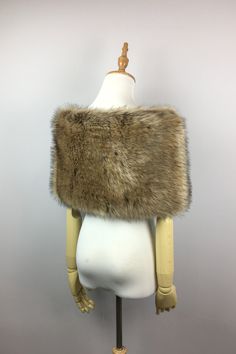 a white mannequin with a fur stole on it's head