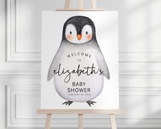 an easel with a penguin on it and the words welcome to elizabeth's baby shower