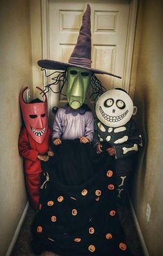 three children dressed up in halloween costumes