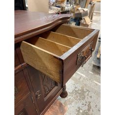 an old wooden dresser with drawers open