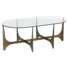 a glass and metal coffee table with two intersecting legs on the bottom, in front of a white background