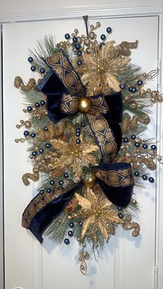 a christmas wreath with blue and gold decorations