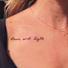 a woman's chest with the words love and light tattooed on her left side