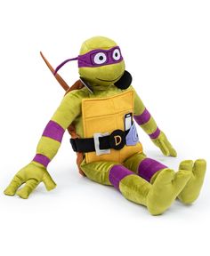 a stuffed turtle with a backpack on it's back and legs, sitting in front of a white background