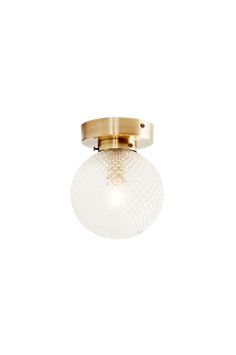 a light fixture with a glass ball on the top and a brass plated base