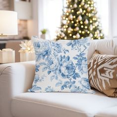 a living room filled with furniture and a christmas tree in the backgroung