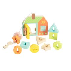 a wooden toy set with various shapes and colors on it's side, including a house