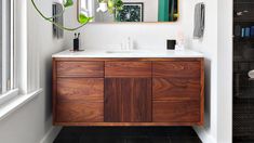 a bathroom with a wooden cabinet and mirror