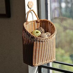 a wicker basket hanging on the side of a window