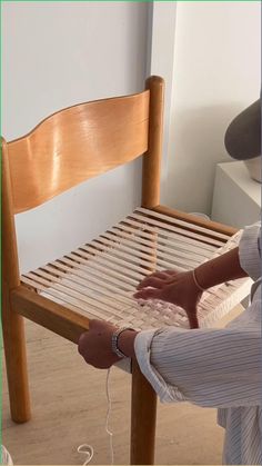 a woman is sitting on a bed frame