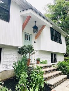 a white house with steps leading up to the front door