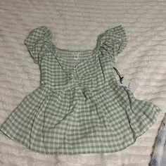 Super Cute Babydoll Top. Gingham Print In A Light Green And Has Never Been Worn Before With Tags Still Intact! Cute Fitted Tops For Picnic, Gingham Tops For Beach In Spring, Plaid Tops For Beach Outings In Spring, Plaid Tops For Beach And Spring Season, Plaid Tops For Spring, Cute Fitted Green Blouse, Summer Short Sleeve Tops For Picnic, Plaid Short Sleeve Beach Top, Cute Green Short Sleeve Blouse