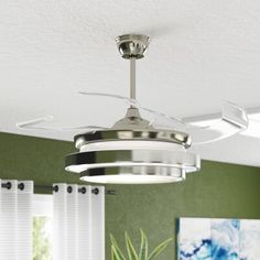 a ceiling fan in a room with green walls