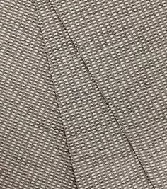 the back side of a gray suit with black and white checkered pattern on it