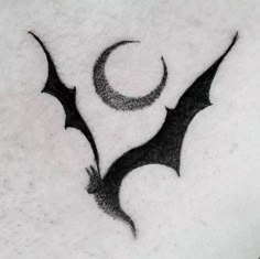 a bat and crescent tattoo on someone's stomach