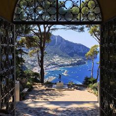 an open door with a view of the ocean and mountains